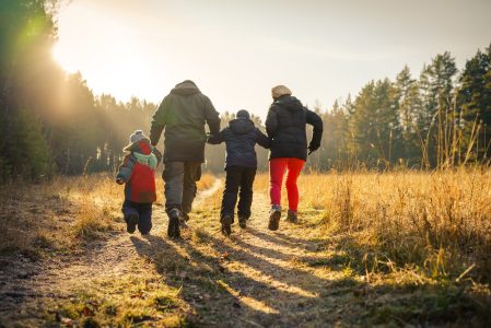 happy family running on country road